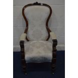 A VICTORIAN ROSEWOOD ARMCHAIR with rose and thistle carving to top, scrolled arms and tapered turned
