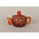A SMALL AMBER COLOURED HARDSTONE TEAPOT, embossed Dragon/Mythical Beast to top of body (some chipped