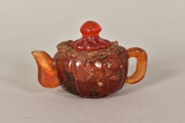 A SMALL AMBER COLOURED HARDSTONE TEAPOT, embossed Dragon/Mythical Beast to top of body (some chipped