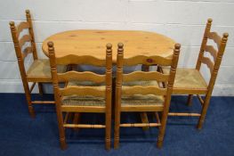 A MODERN PITCH PINE KITCHEN TABLE, with four rush seated chairs (s.d) (5)