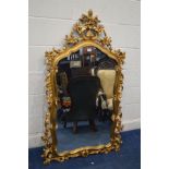 A MODERN GILT WOOD SHAPED WALL MIRROR with foliate fretwork frame, height 144cm x width 80cm