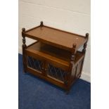 AN OLD CHARM OAK TWO TIER TROLLEY, with double led glazed doors, width 84cm x depth 48cm x height