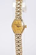 A LADIES 9CT GOLD MARVIN REVUE QUARTZ WRISTWATCH, with a tonneau gold dial, baton markers,