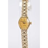 A LADIES 9CT GOLD MARVIN REVUE QUARTZ WRISTWATCH, with a tonneau gold dial, baton markers,