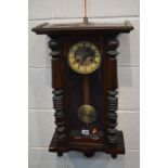 AN EARLY 20TH CENTURY SMALL VIENNA WALL CLOCK with a enamel and brass face behind a glazed door