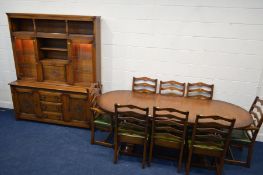 A REPRODUCTION MELLOWCRAFT OAK DINING SUITE, comprising an extending table with rounded ends, one