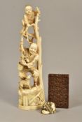 A LATE 19TH CENTURY JAPANESE IVORY OKIMONO, carved as a child standing at the top of some branches