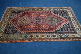 AN EARLY 20TH CENTURY BALUCH RED, BLACK AND ORANGE GROUND RUG, with a multi strap border,