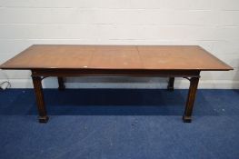 A REPRODUCTION MAHOGANY AND BANDED RECTANGULAR EXTENDING DINING TABLE, on square reeded legs, with