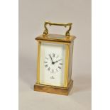 AN IMPERIAL BRASS CASED CARRIAGE CLOCK, white enamel dial with Roman numerals, the backplate
