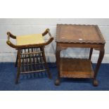 AN EDWARDIAN MAHOGANY PIANO STOOL, with twin handles, on out splayed legs united by spindles,