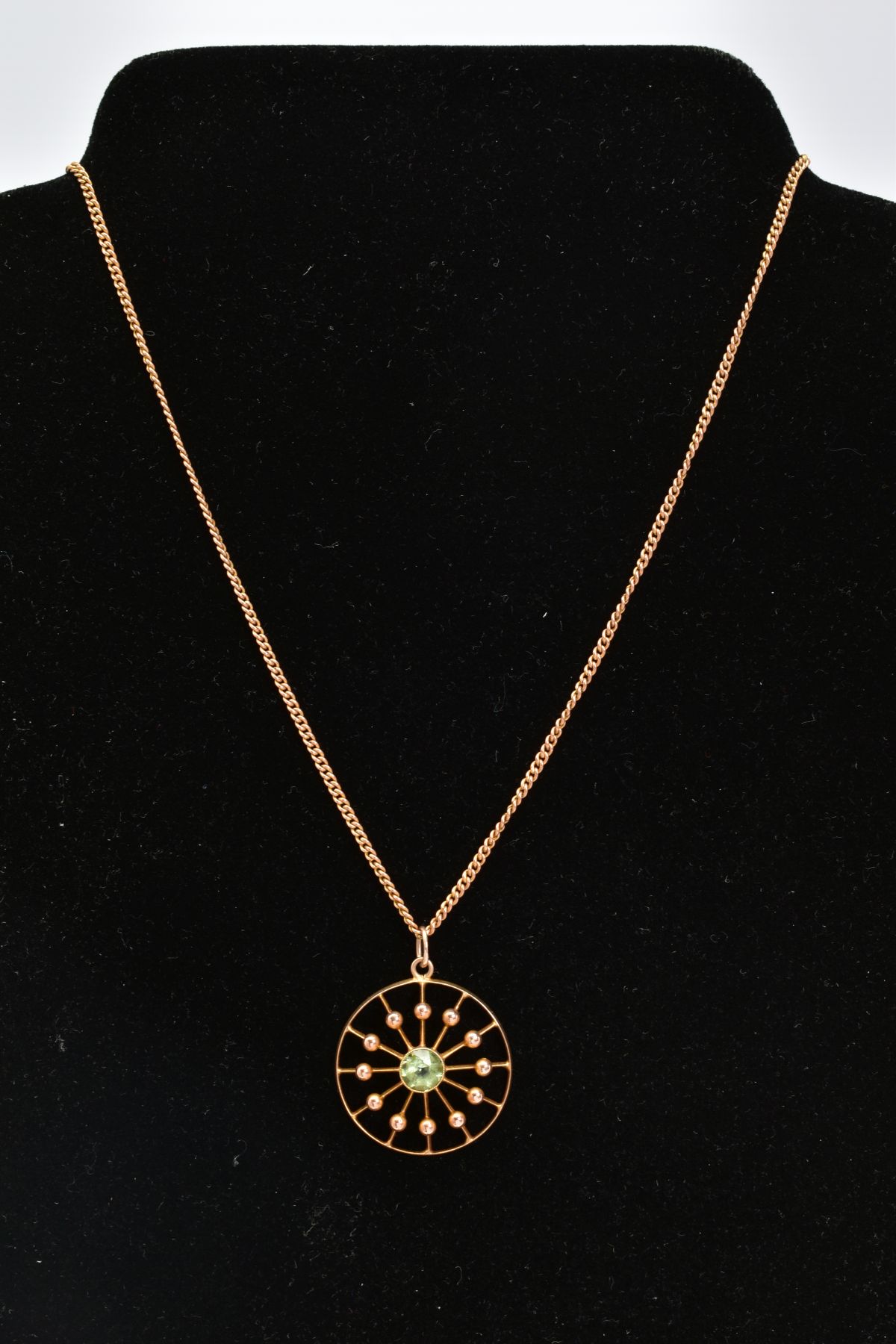 AN OPENWORK PENDANT NECKLACE, the circular openwork panel pendant set with a central circular cut