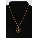 AN OPENWORK PENDANT NECKLACE, the circular openwork panel pendant set with a central circular cut