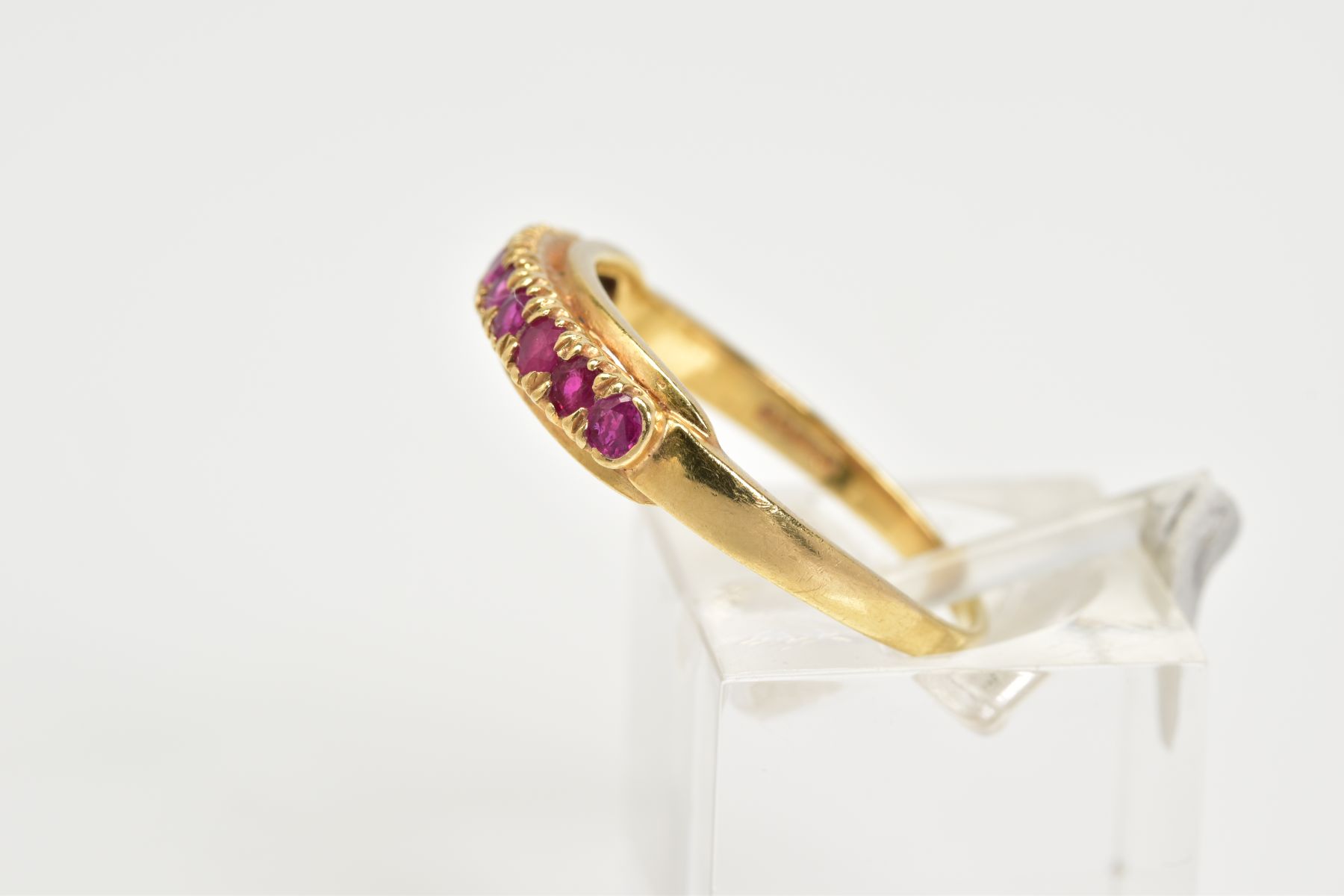 AN 18CT GOLD RUBY RING, of half hoop design set with nine circular cut claw set rubies, to a plain - Image 2 of 3