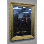 A MODERN GILT WOOD FRAMED BEVELLED EDGE WALL MIRROR, 83cm x 114cm