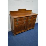 AN EDWARDIAN WALNUT SIDEBOARD with a raised back, four drawers, above double panelled doors, width
