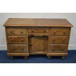 A VICTORIAN PINE SIDEBOARD, six drawers flanking a single drawer above a cupboard door, with