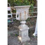 A LARGE COMPOSITE THREE PIECE GARDEN URN ON STAND, with foliate and hunting scene detail to body