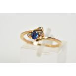 A SAPPHIRE AND DIAMOND RING, of crossover design set with a central oval cut sapphire flanked with
