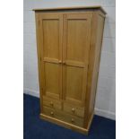 A MODERN GOLDEN OAK DOUBLE DOOR WARDROBE, above two short and one long drawer, width 95cm x depth