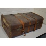 A DISTRESSED VINTAGE TRAVELLING TRUNK, with travel labels, width 84cm x depth 54cm x height 36cm