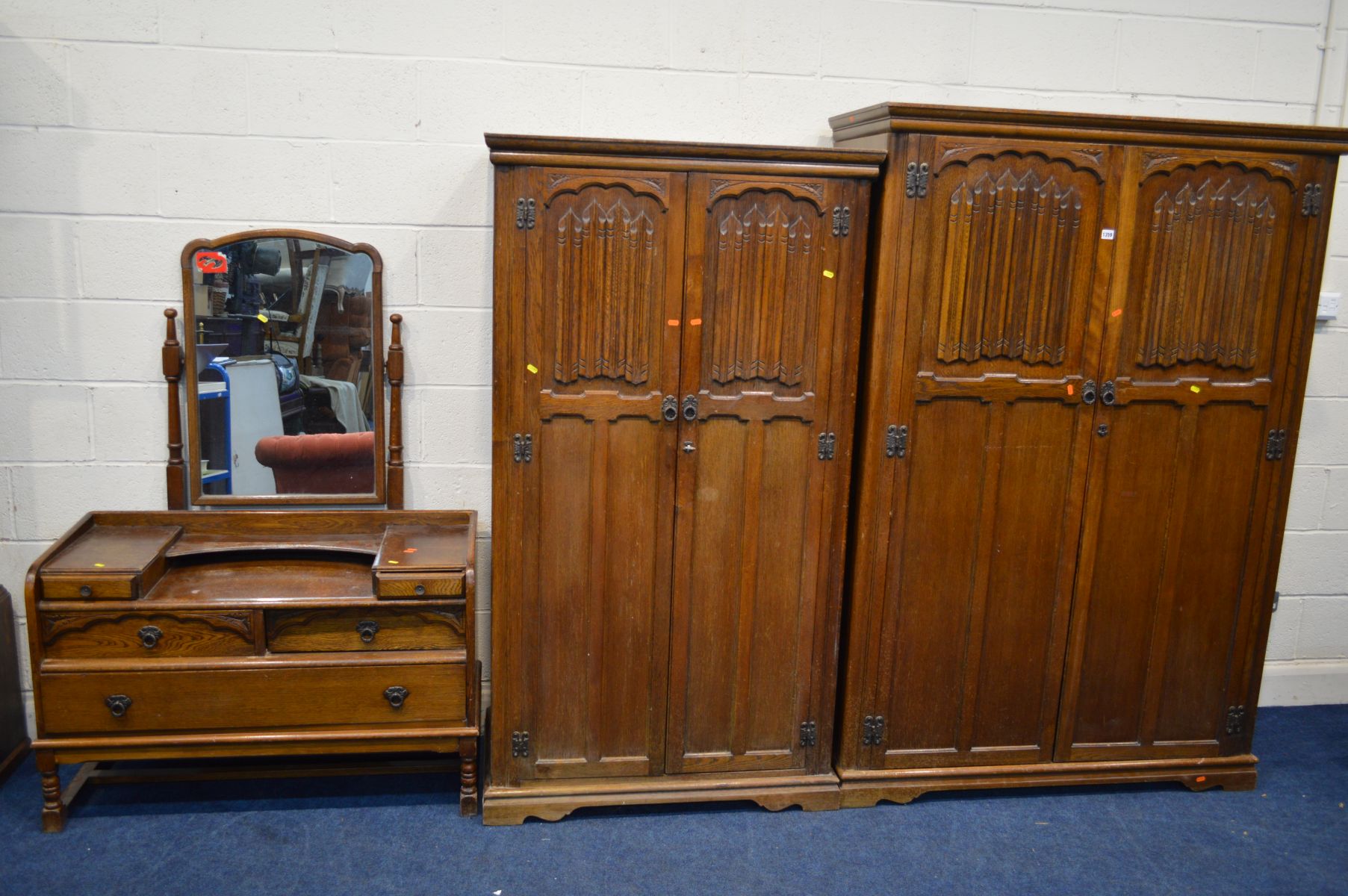 AN OLD CHARM OAK THREE PIECE BEDROOM SUITE comprising of two sized double door wardrobes, largest