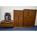 AN OLD CHARM OAK THREE PIECE BEDROOM SUITE comprising of two sized double door wardrobes, largest