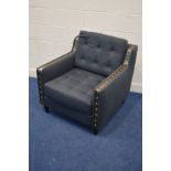 A CHARCOAL UPHOLSTERED AND BRONZED ARMCHAIR on cylindrical legs, width 85cm x depth 88cm x height