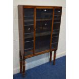 A MAHOGANY GLAZED SINGLE DOOR BOOKCASE, with two fixed shelves on four earlier tuned legs, width