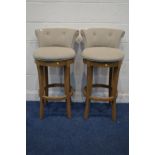 A SET OF THREE MODERN OATMEAL SWIVEL BAR STOOL on a hardwood base