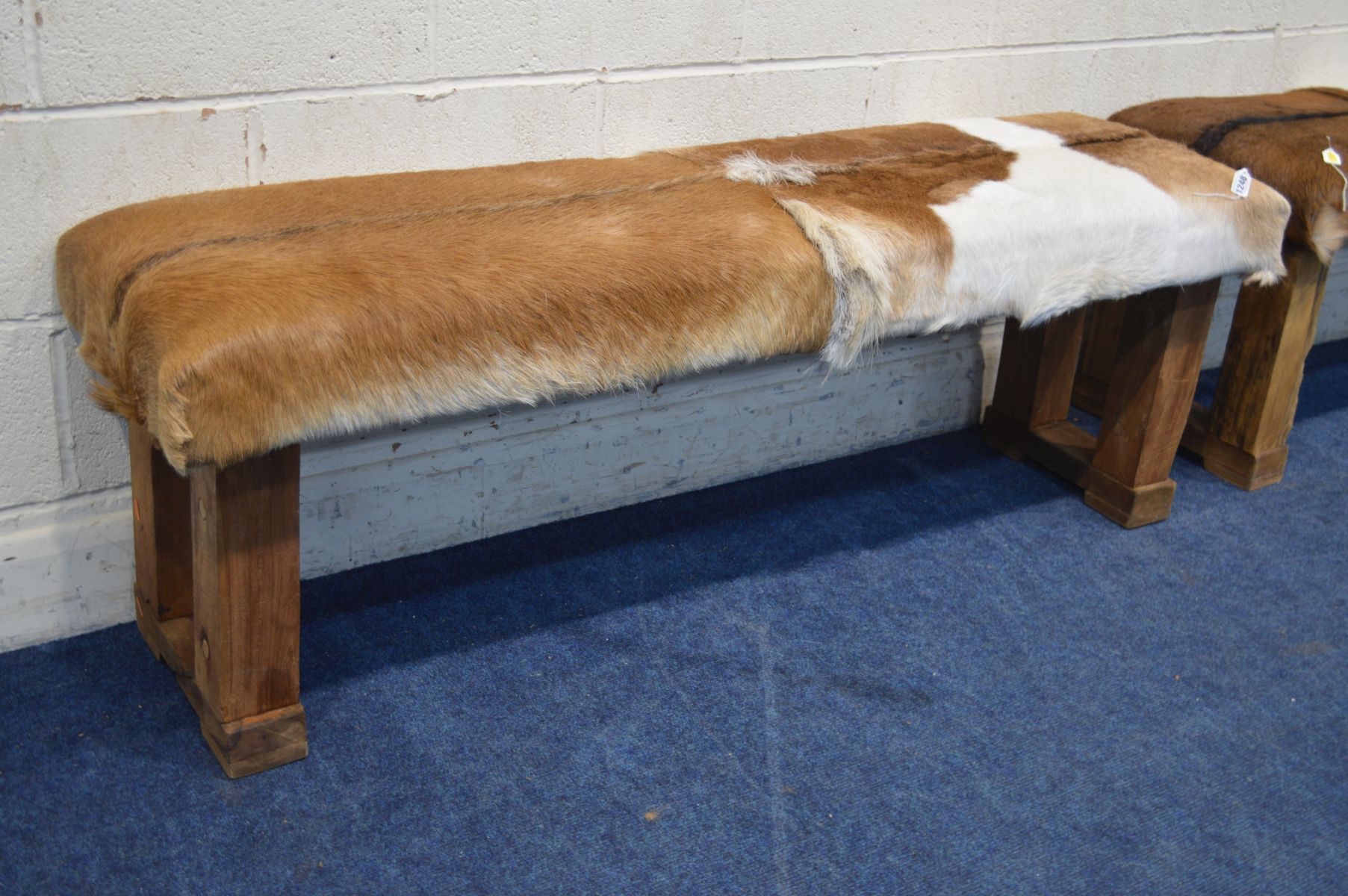 A PAIR OF RUSTIC RECTANGULAR STOOLS with animal hide seat covers, width 152cm x depth 44cm x - Image 2 of 3
