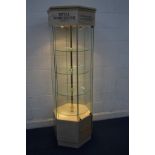 A HEXAGONAL ILLUMINATED SHOP DISPLAY CABINET, with four tier electrical spinning glass shelves, four