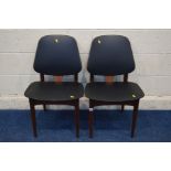 A PAIR OF ELLIOTS OF NEWBURY TEAK DINING CHAIRS with black leatherette back and seats