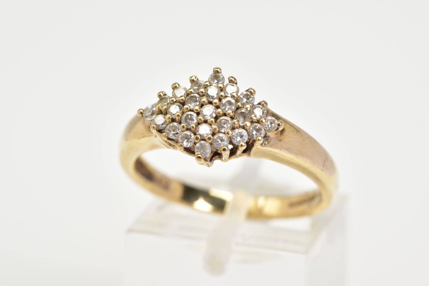 A 9CT GOLD CUBIC ZIRCONIA RING, set with a lozenge of claw set cubic zirconia, to a plain polished