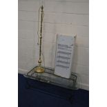 A MODERN GLASS TOPPED WROUGHT IRON COFFEE TABLE together with a brass standard lamp and a boxed