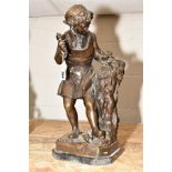 A REPRODUCTION BRONZE FIGURE TITLED 'MICHELANGIOIO', cast as a sculptor carving a mask, indistinctly