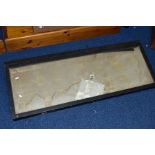 AN ANGLED GLASS TOP WOODEN TABLE TOP DISPLAY CABINET, top is screwed shut, some evidence of water