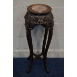 AN ORIENTAL ROSEWOOD AND MARBLE TOPPED PLANT STAND, with carved floral decoration, on four shaped