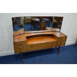 A MID 20TH CENTURY TEAK DRESSING TABLE, with a triple mirror and five drawers, width 153cm x depth