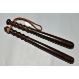 TWO TURNED WOODEN TRUNCHEONS