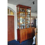 A MAHOGANY GLAZED DISPLAY CABINET ON A PANELLED TWO DOOR BASE, 124cm wide x 50cm deep x 268cm high
