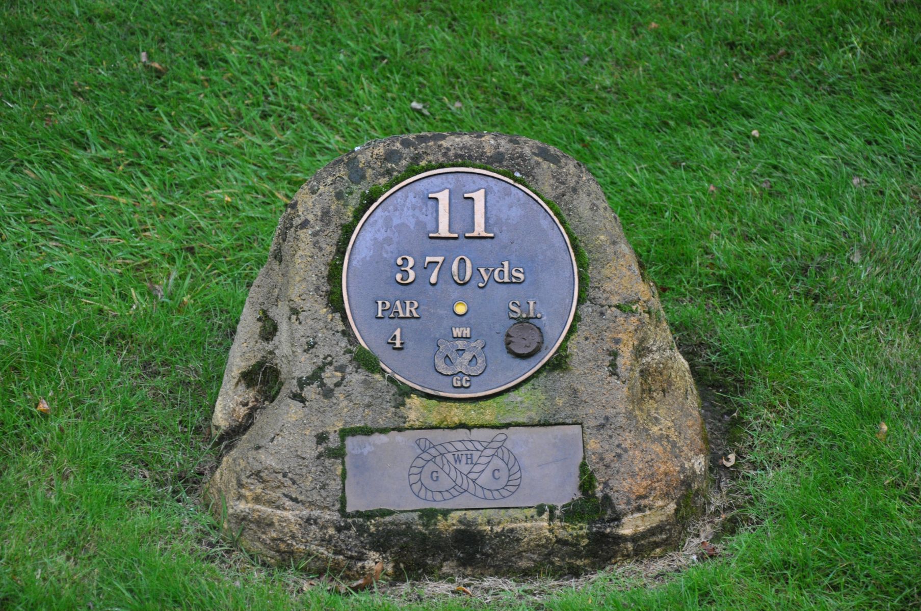 THE YELLOW TEE MARKER FOR HOLE ELEVEN