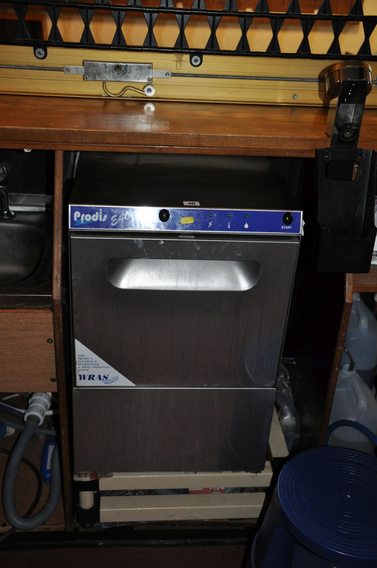 A PRODIS E40 STAINLESS STEEL GLASS WASHER, with two plastic glass trays, 45cm wide x 54cm deep x