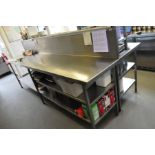 A STAINLESS STEEL CATERING TABLE, with a stainless plate back, 307cm wide x 59cm deep and 90cm to