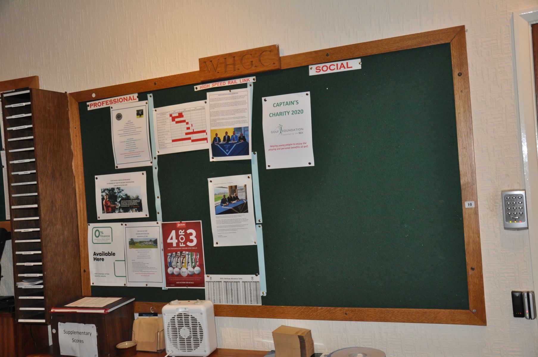 AN OAK AND GREEN BAIZE NOTICE BOARD, with W.H.G.C. plaque to top, 183cm long x 2cm deep x 106cm high