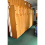 A 354CM LONG RUN OF TWENTY OAK DOORED LOCKERS, ten with 134.5cm doors and ten with 49.5cm doors with