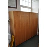 A RUN OF SIX TALL OAK FACED LOCKERS, constructed in two three door sections with a top and one decor