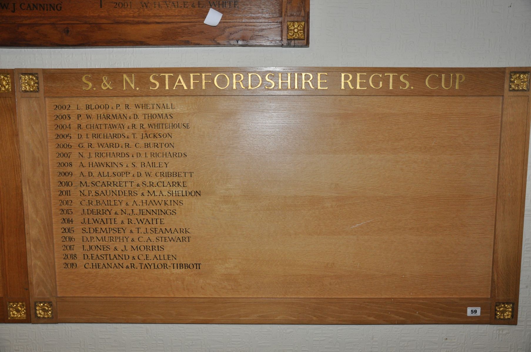 AN OAK FACED HONOURS BOARD, with gilt rose bosses to each corner, Winners of S & N Staffordshire