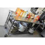 A STAINLESS STEEL CATERING TABLE, with wheels 160cm wide x 65cm deep x 85cm high (food stuffs or