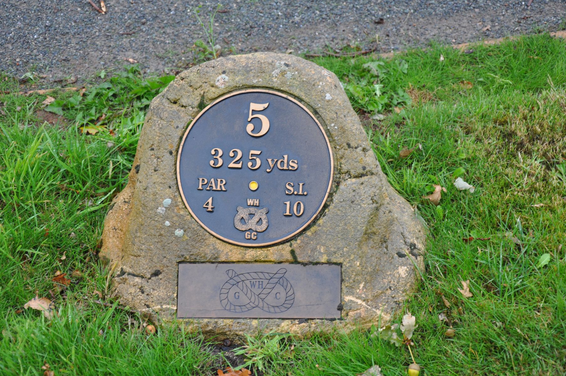 THE YELLOW TEE MARKER FOR HOLE FIVE